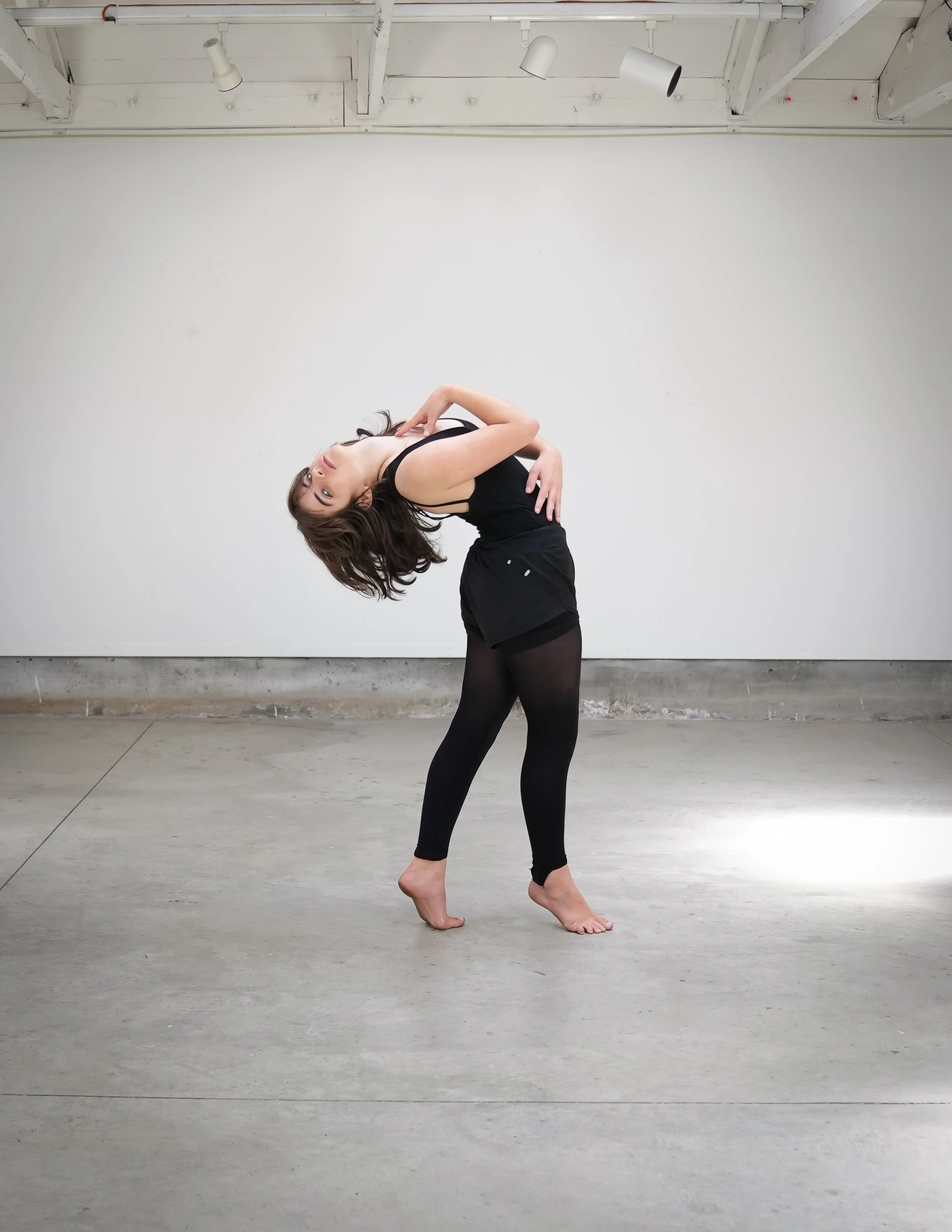 A TWDCC dancer performing contemporary jazz in the studio.