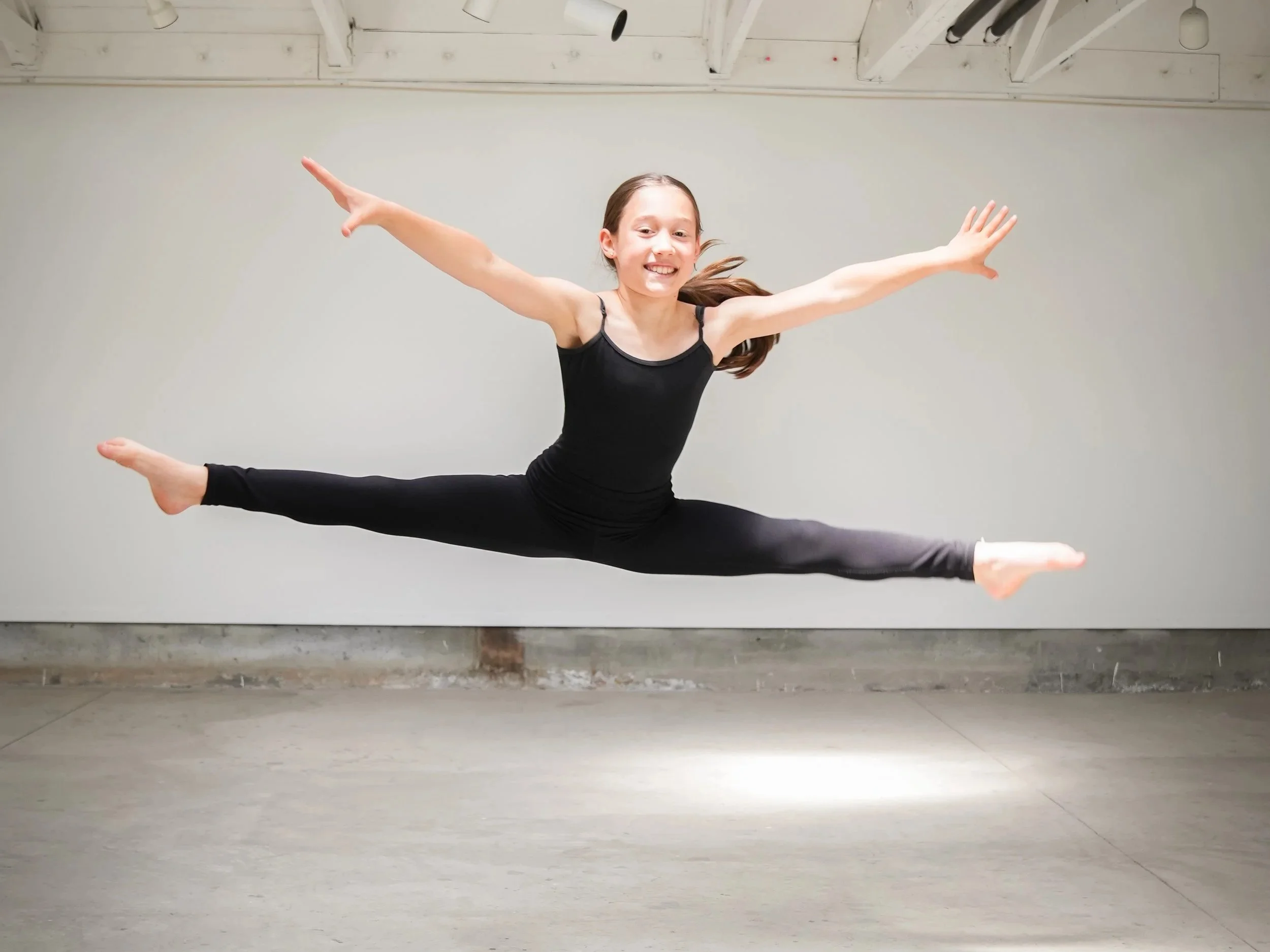 A TWDCC dancer performing jazz in the studio.