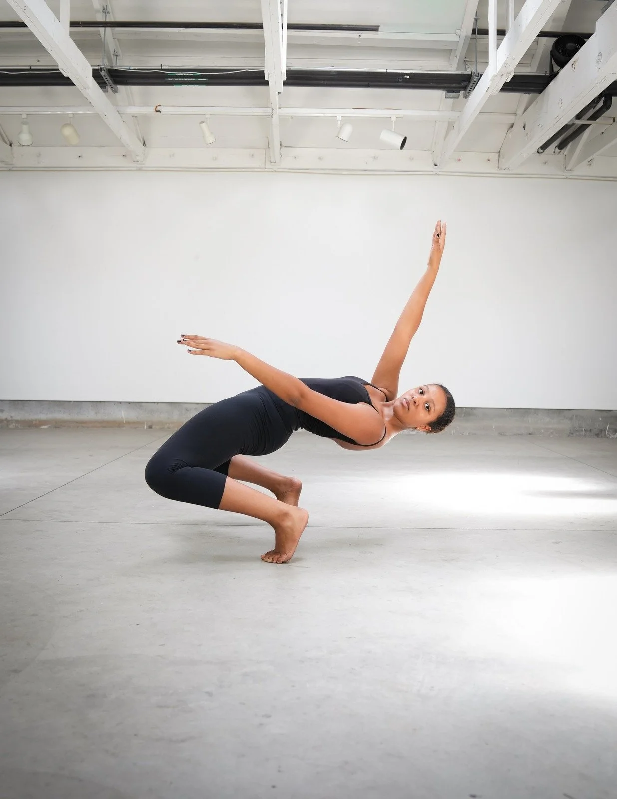 A TWDCC dancer performing modern dance in the studio.