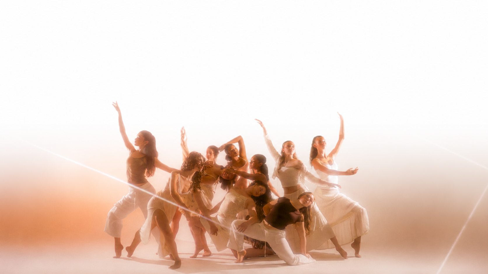 TWDCC Youth Company dancers in a warm, light-filled studio portrait.