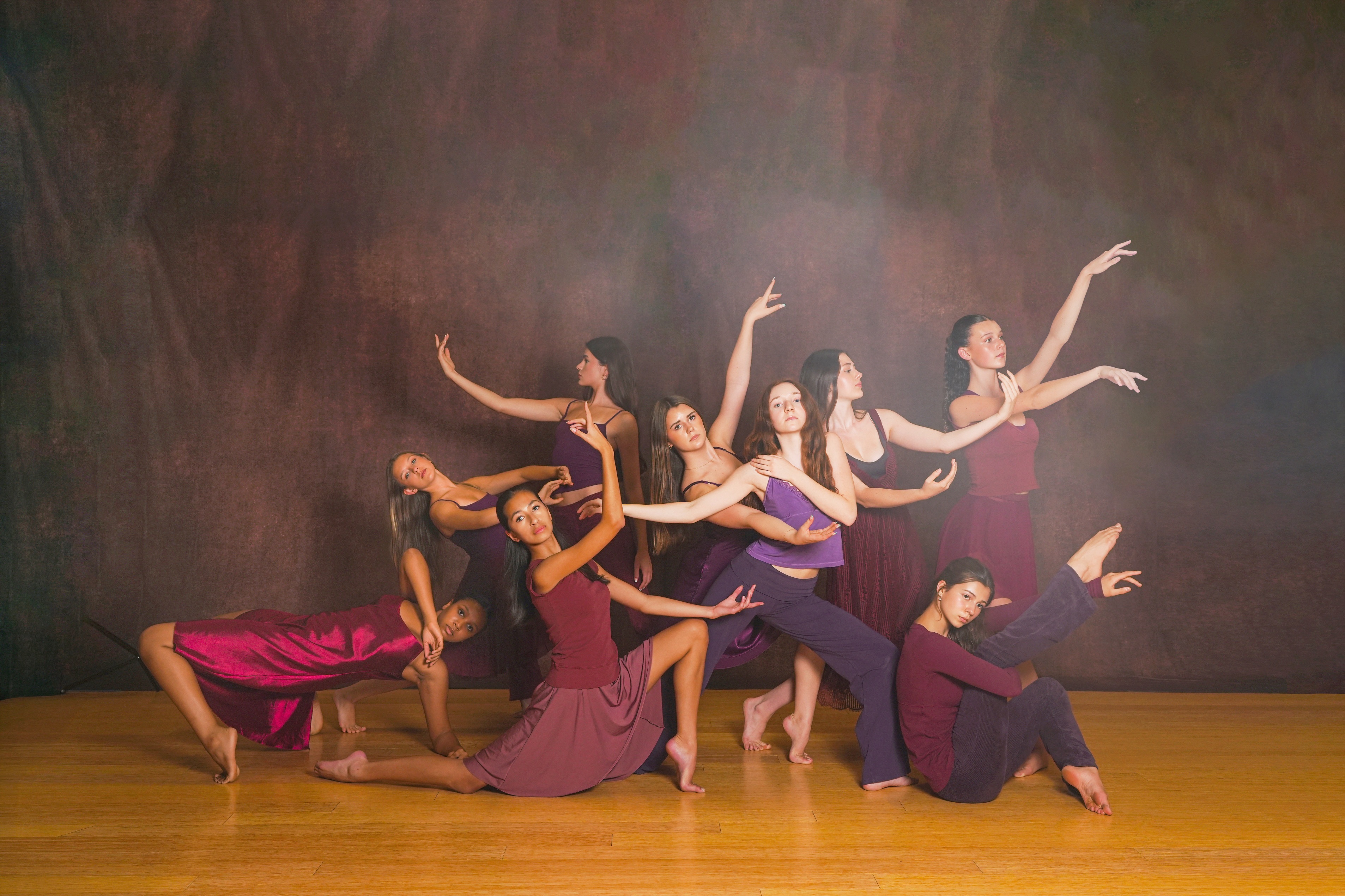 TWDCC dancers perform together in burgundy costumes.
