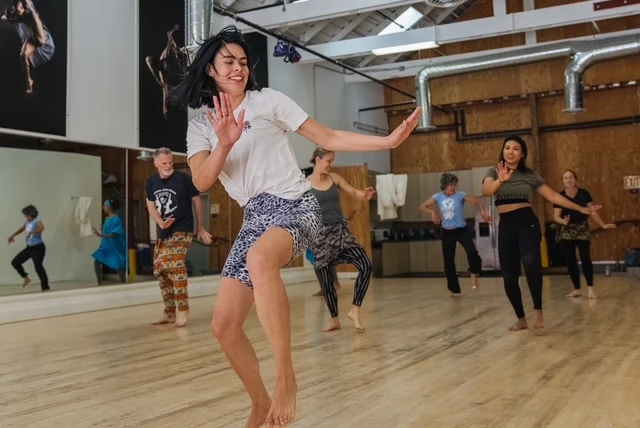 Adult dance students practicing in the studio.