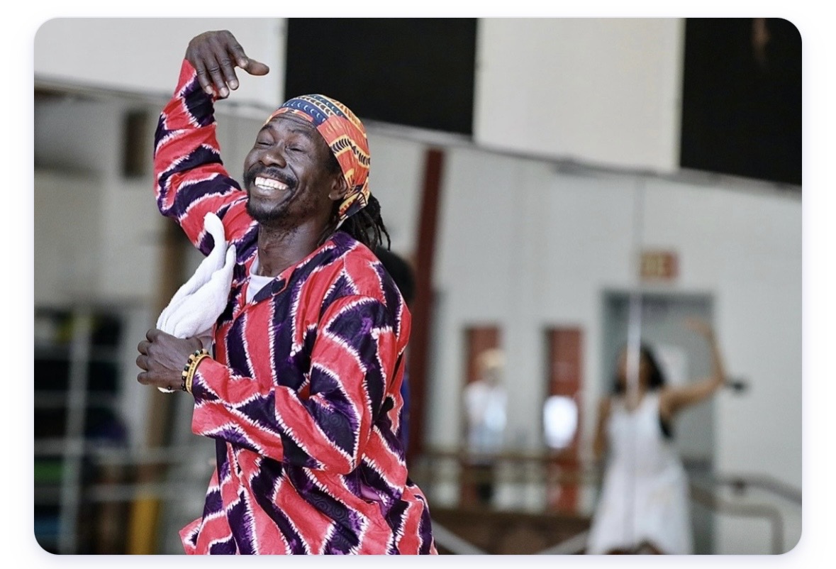 Visiting artist dancing with students in class.