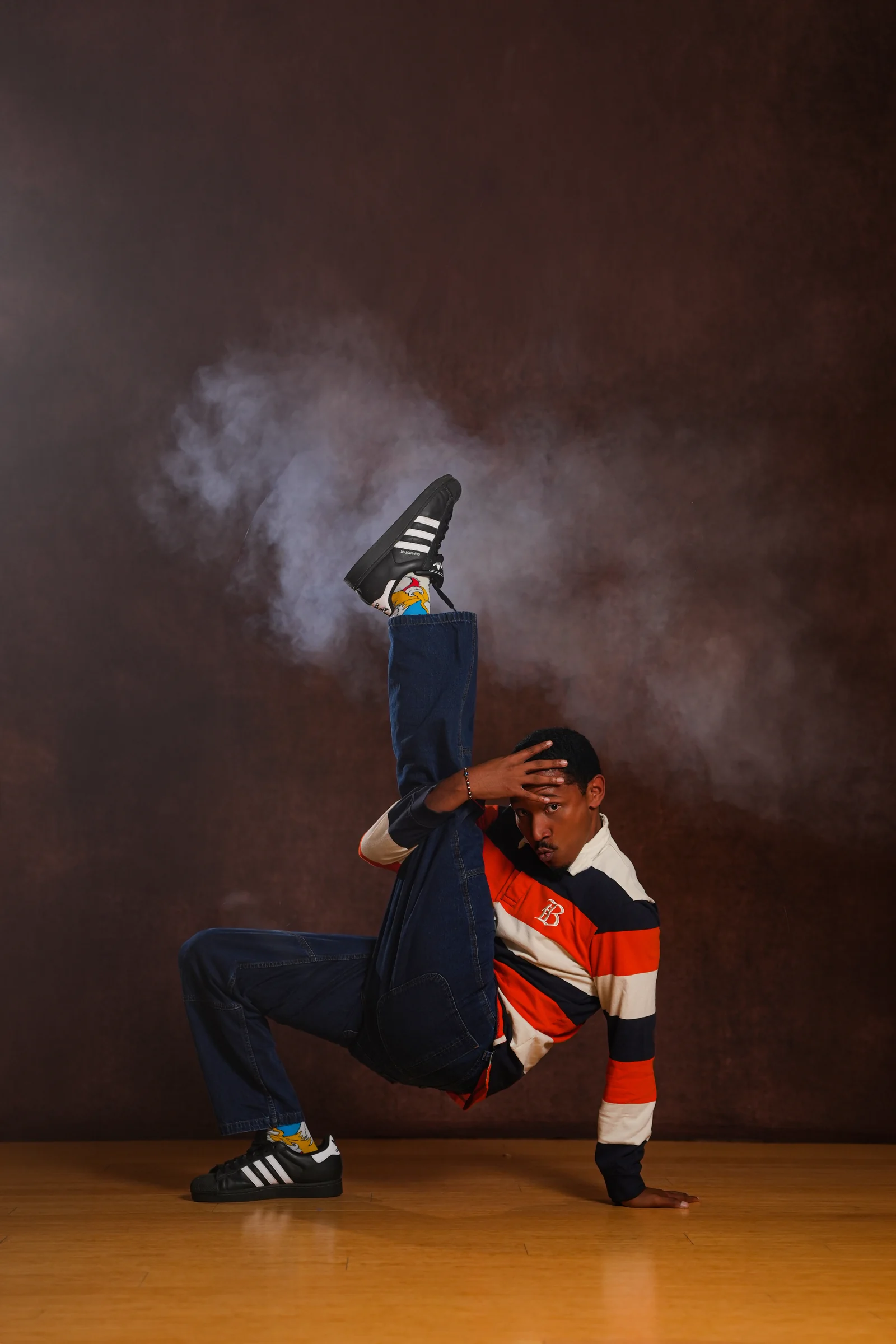Eddie Standifer performing a one-handed breakdance move.