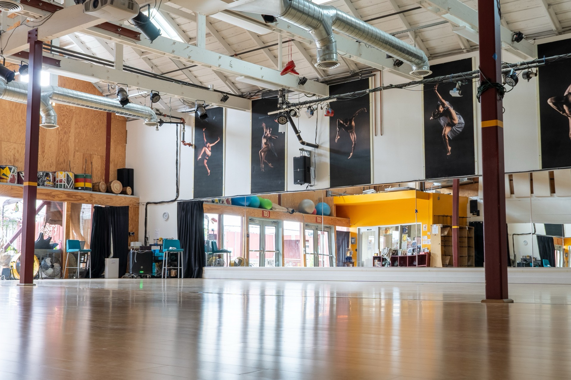 Natural light fills the wood-floor dance studio.